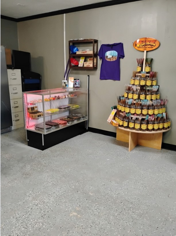 Incense display and bakery products in shop corner.