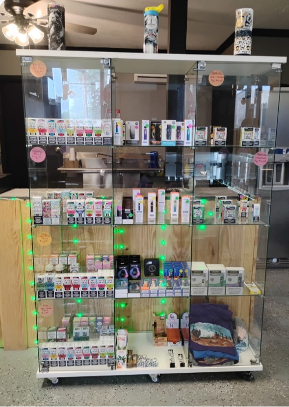 Glass display case with vape products and accessories.